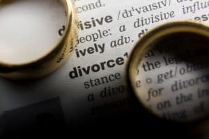 Two rings next to a dictionary definition of divorce